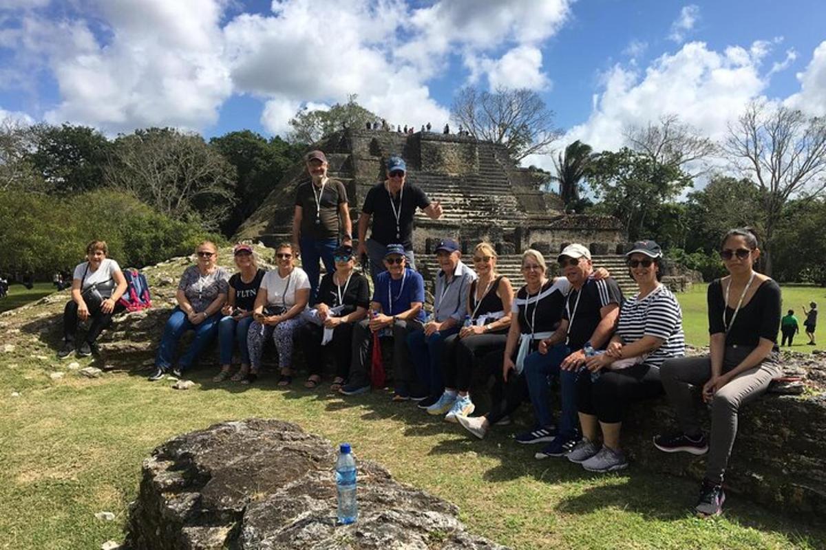 a group of people posing for a picture in front of a temple