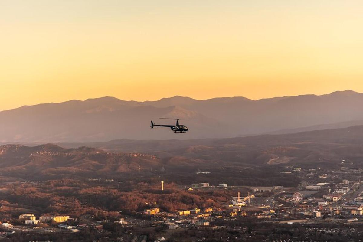 a helicopter flying over a city at sunset