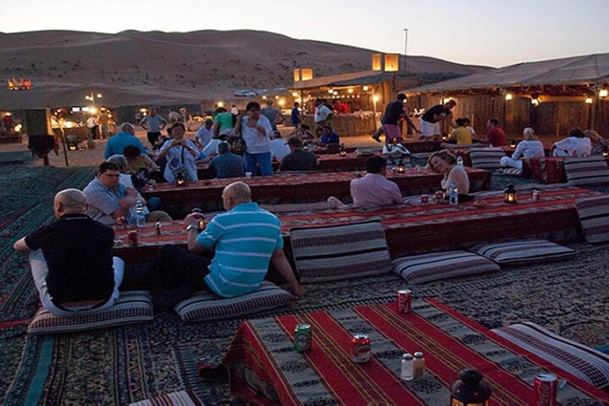 a group of people playing chess in the desert