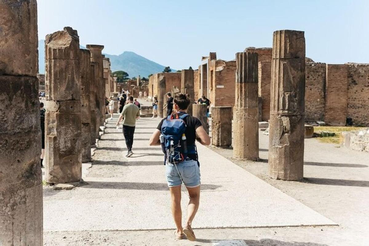 a man with a backpack walking through the ruins