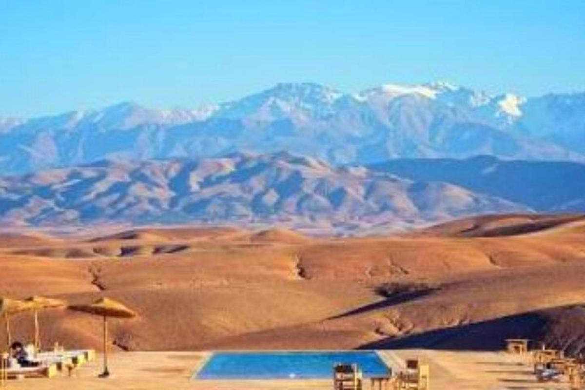a view of a desert with mountains in the background