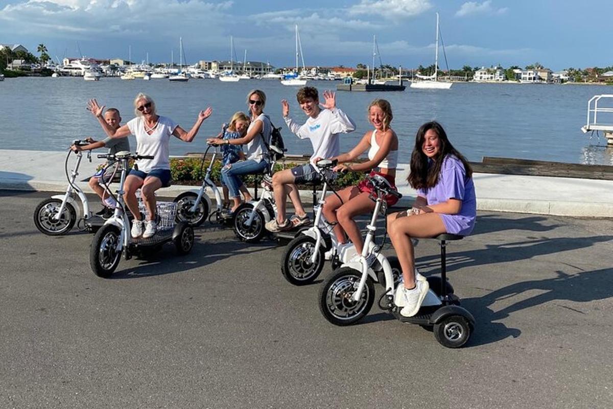 a group of people riding on scooters by the water