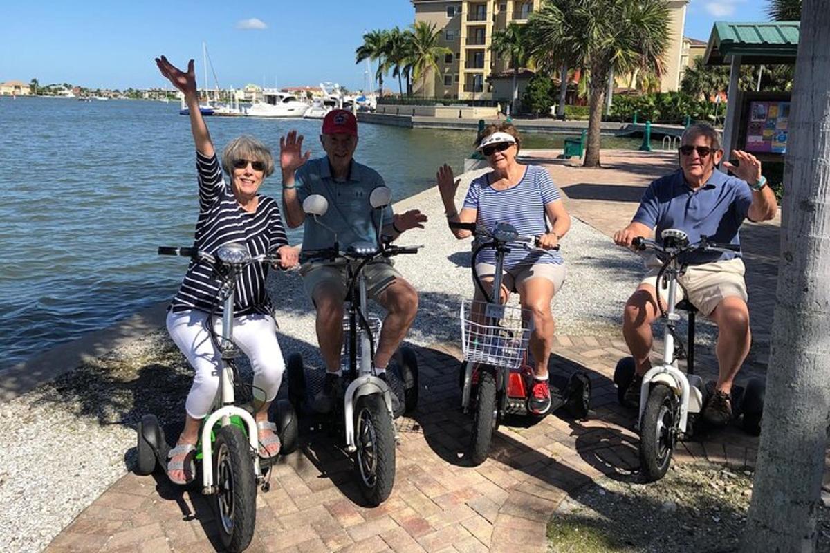 a group of people sitting on bikes by the water