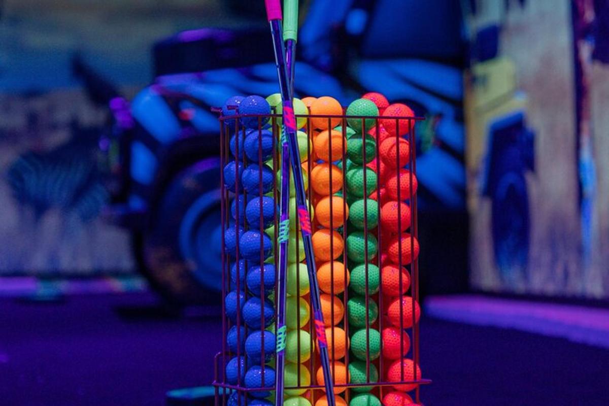 a vase filled with colored balls sitting on a table