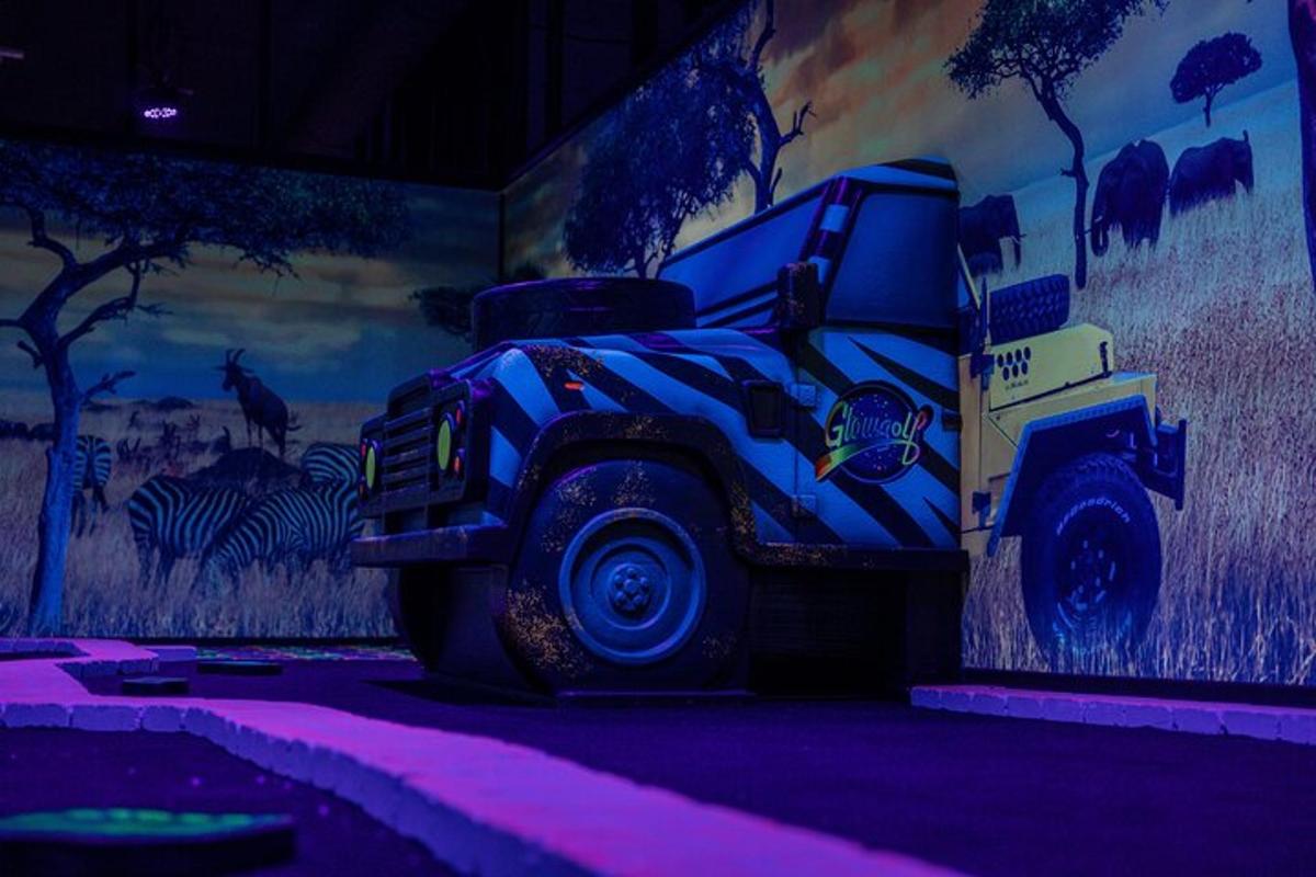 a painting of a truck on a wall with zebras