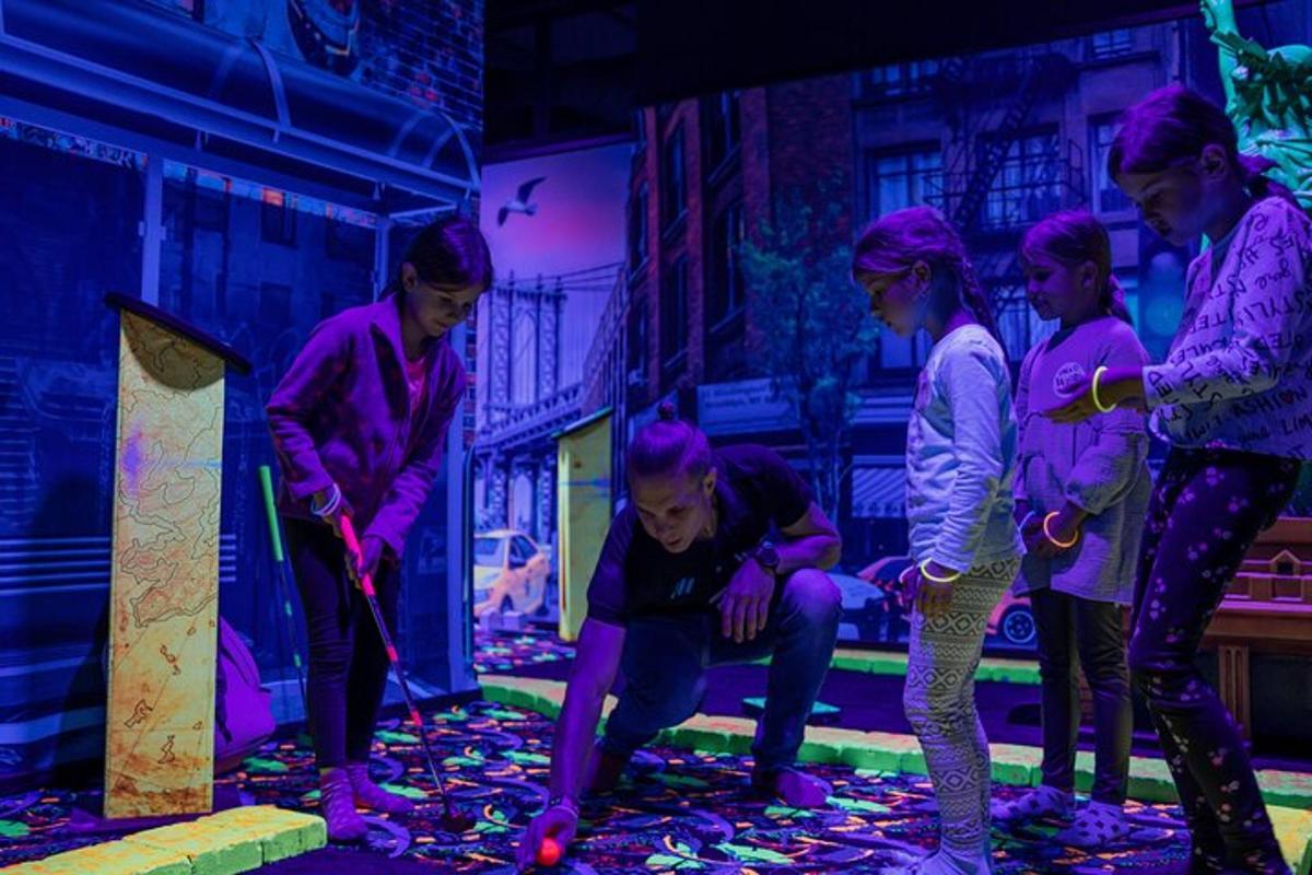 a group of girls are playing with paint on a floor