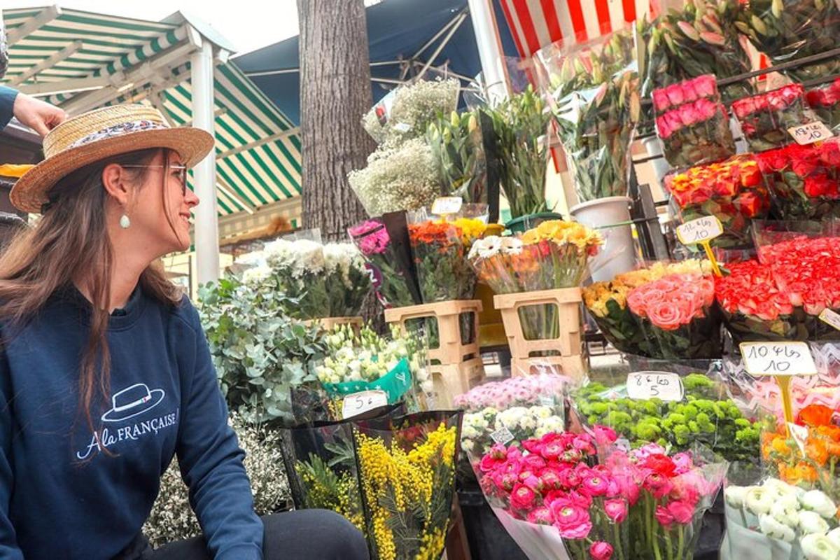 uma mulher sentada em frente a um mercado de flores