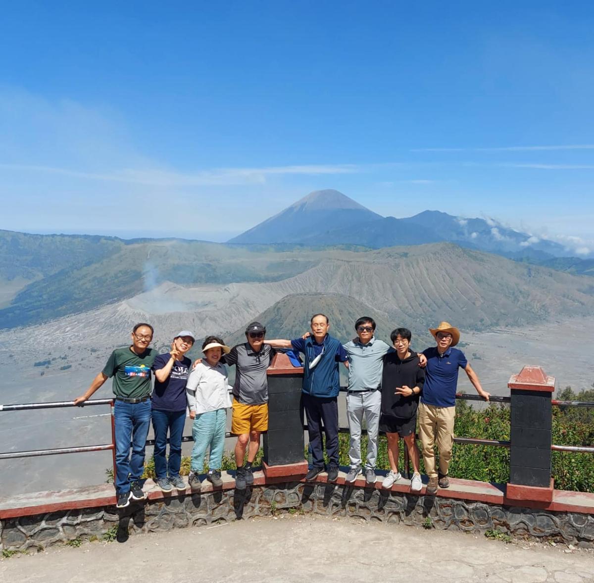 a group of people posing for a picture in the mountains