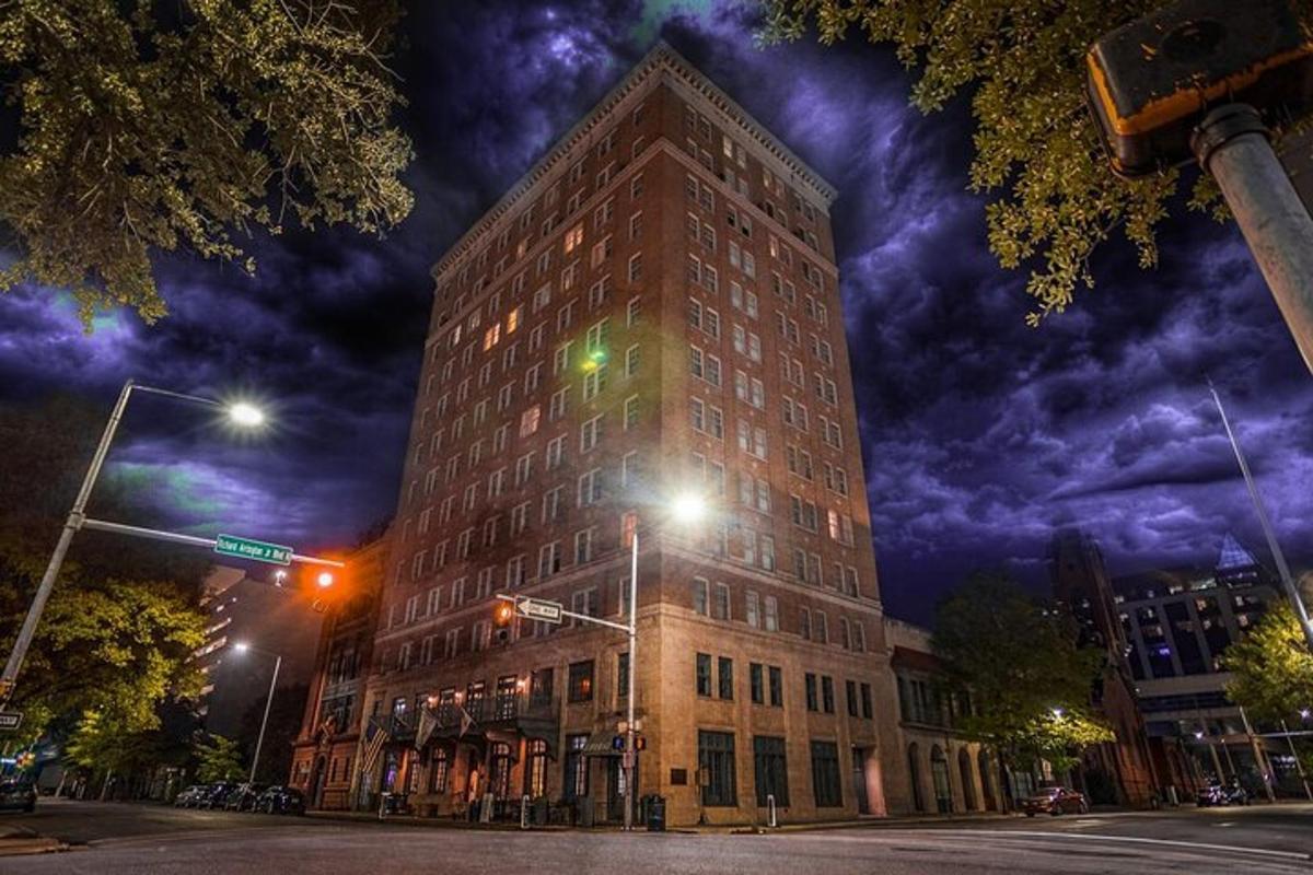 a tall building on a city street at night