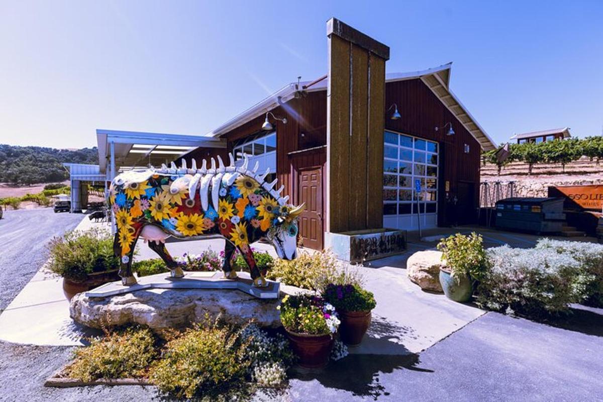 a statue of a cow in front of a building
