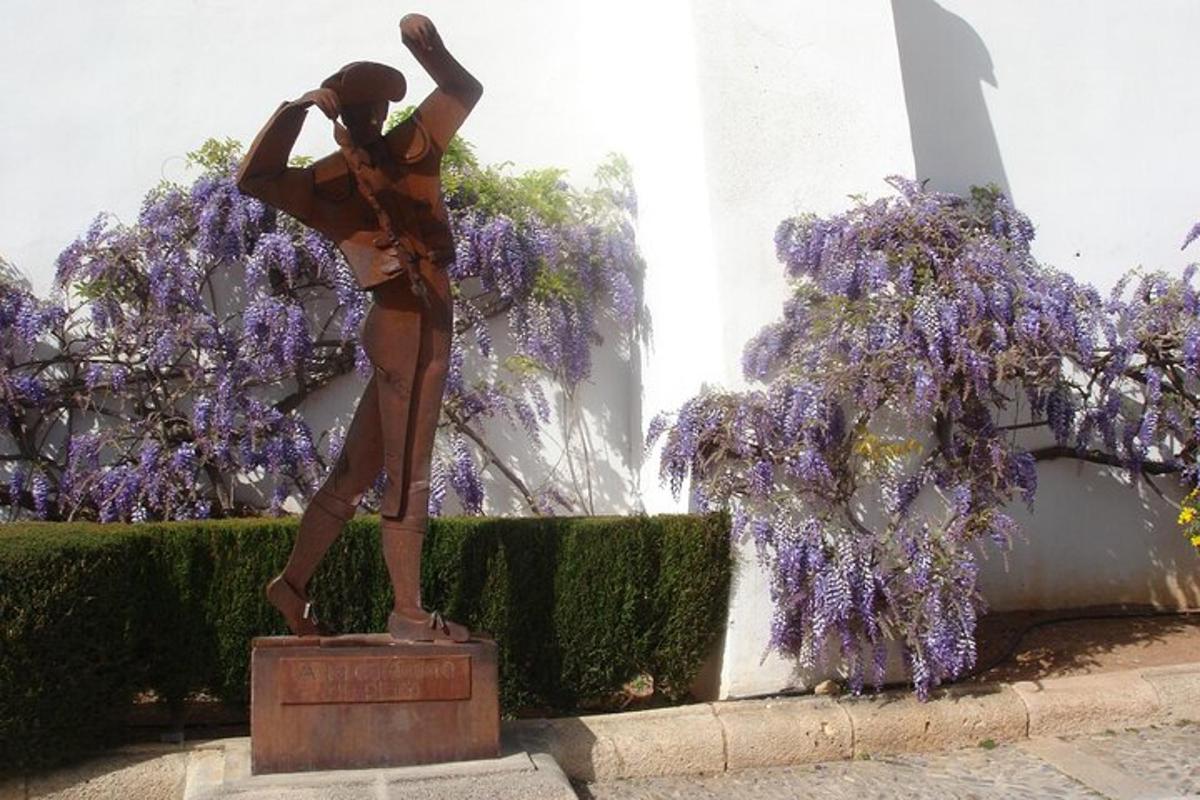 a statue of a woman standing in front of a fountain