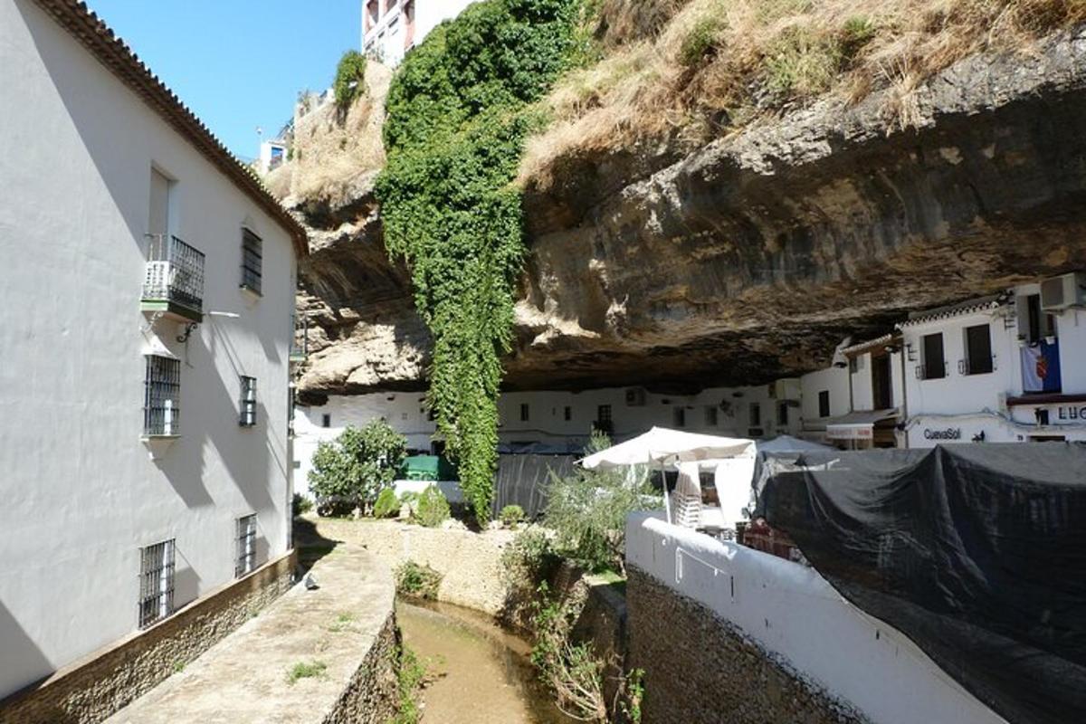 a group of buildings next to a mountain