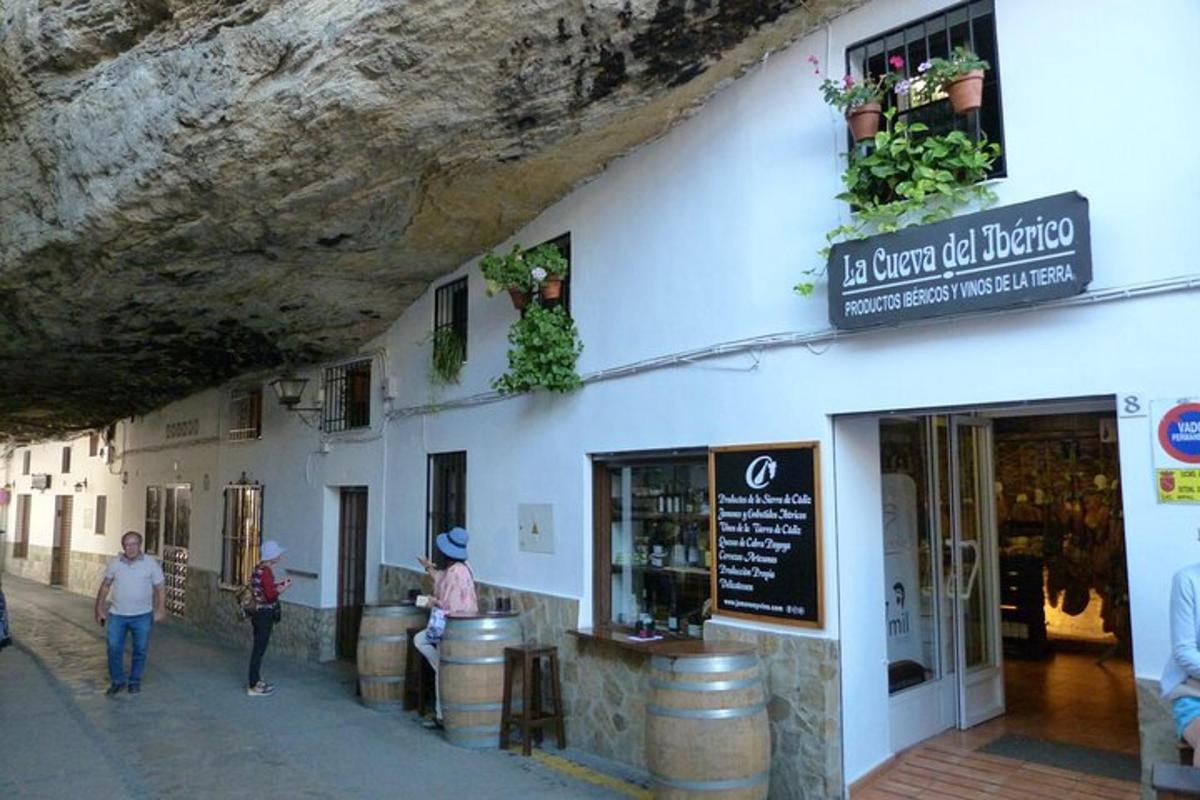 a building with people walking in front of a store