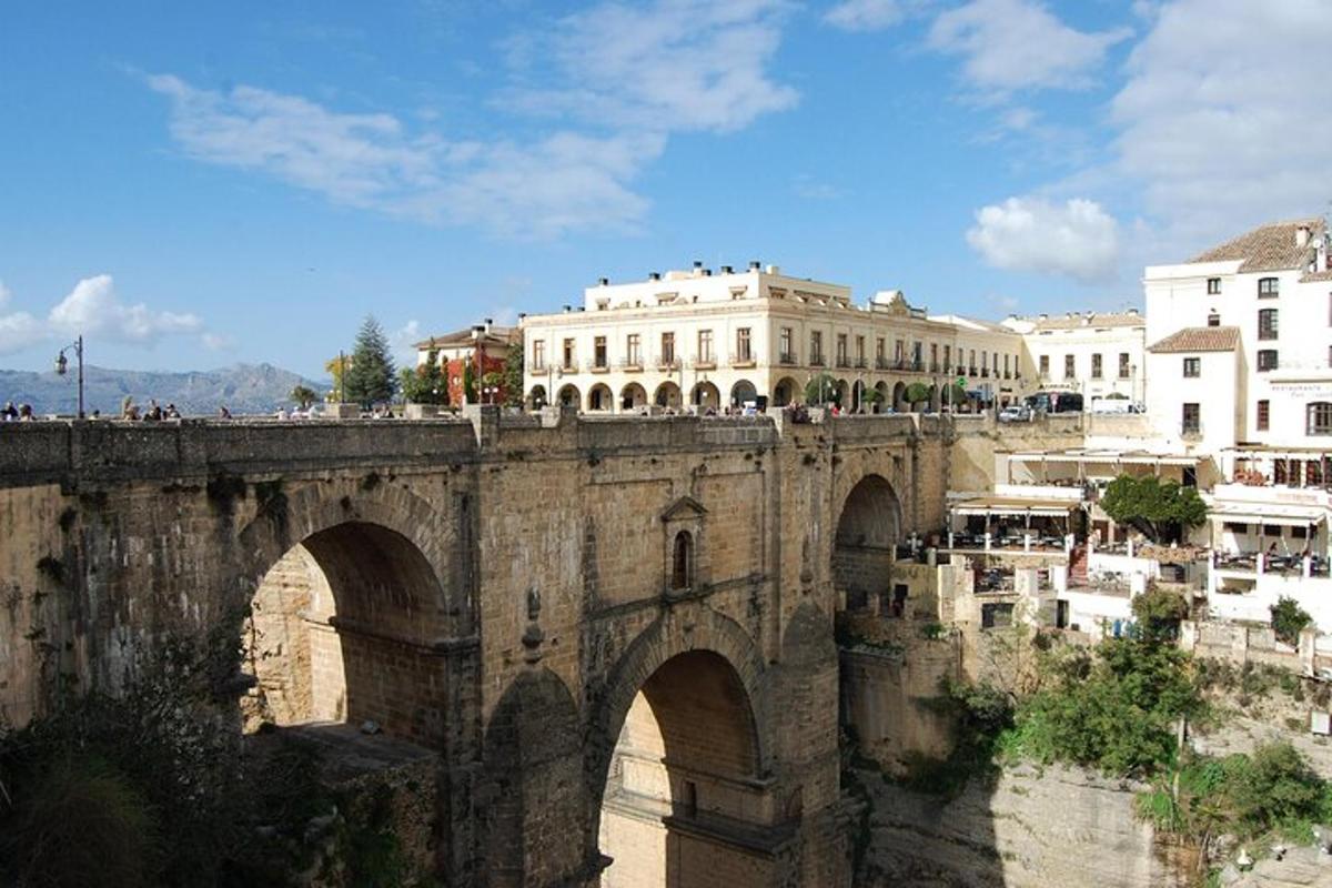 an old stone bridge over a river with buildings