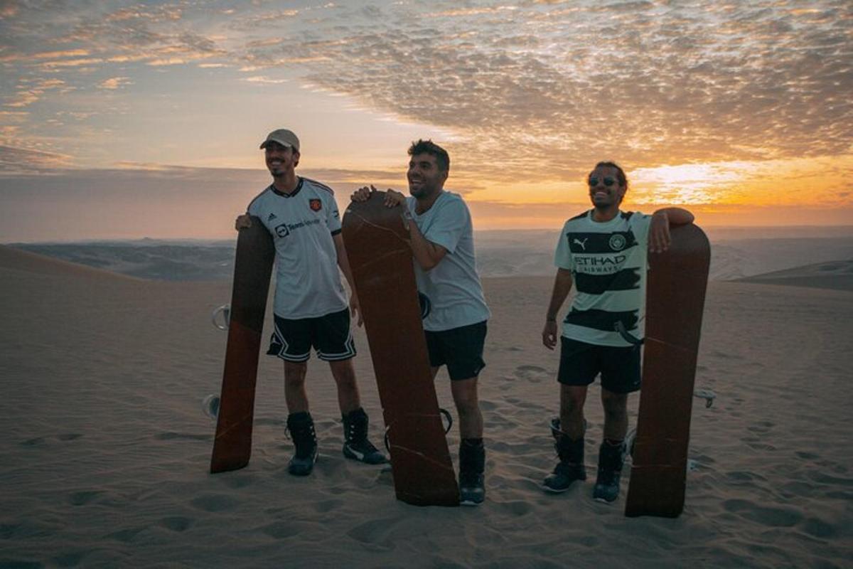 three men standing on the beach holding skateboards