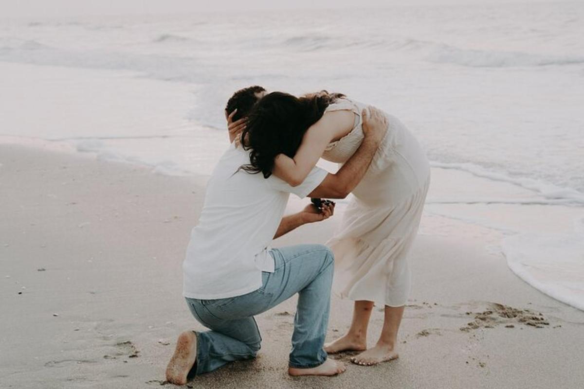 a man and a woman standing on the beach