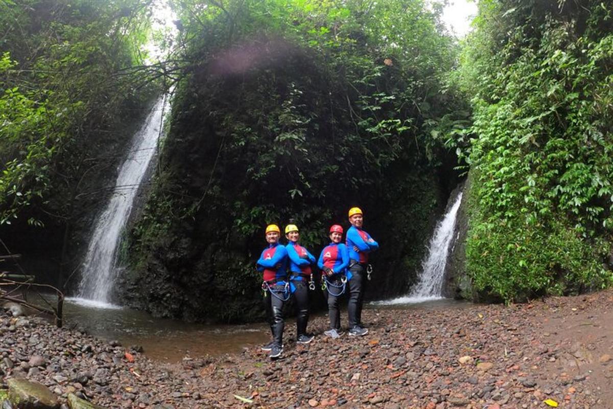 a group of people standing in front of a waterfall