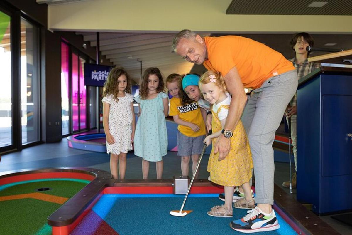 a man playing golf with a group of children