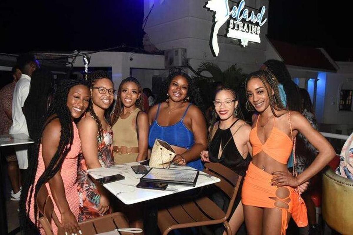 a group of women standing around a table at a party