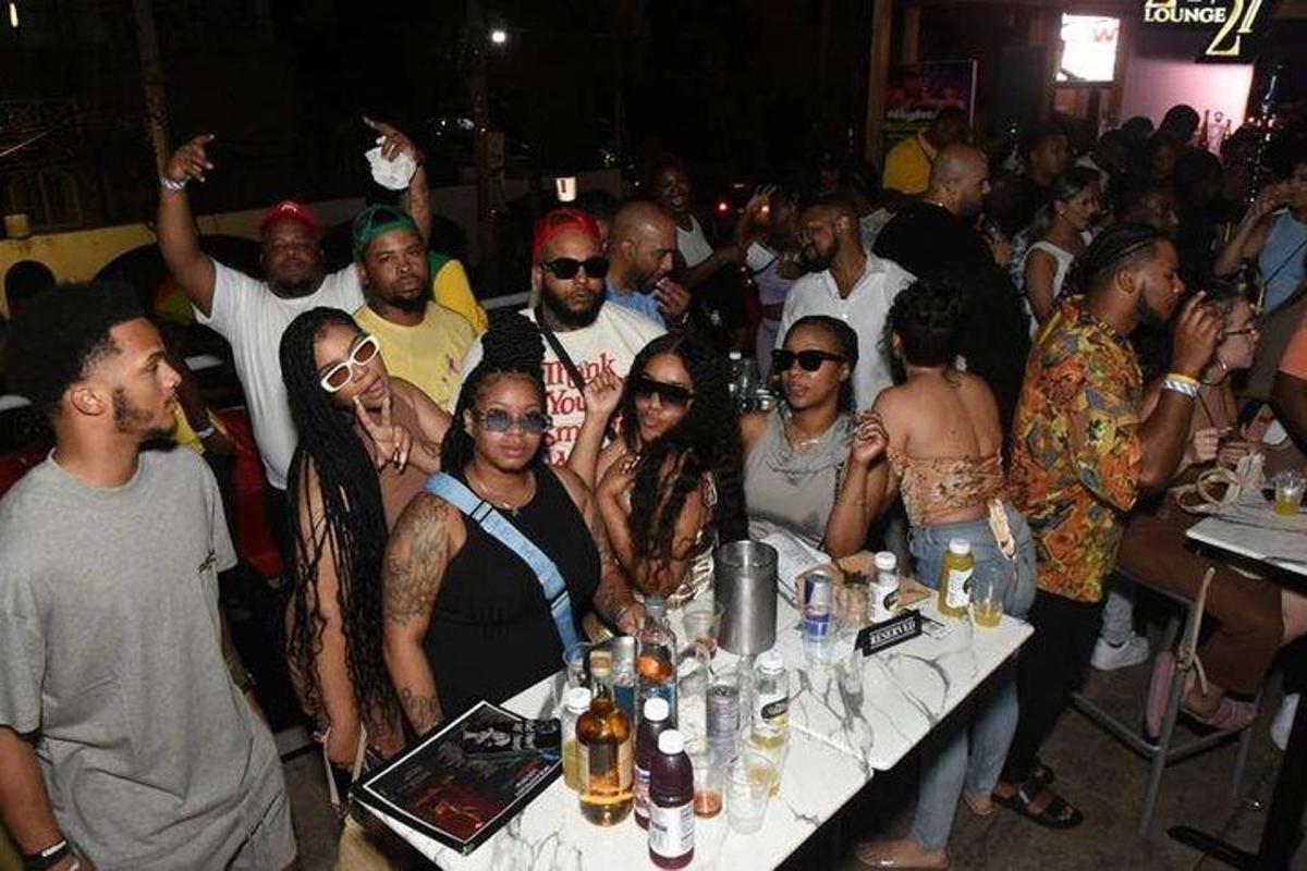 a group of people standing around a table