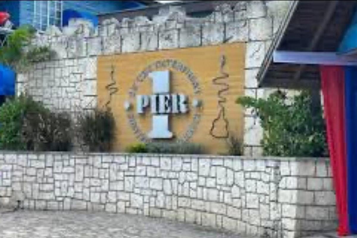 a sign on a stone wall with a pter