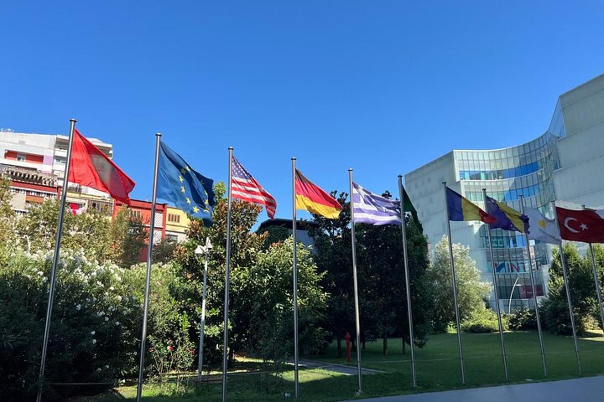 a bunch of flags in front of a building