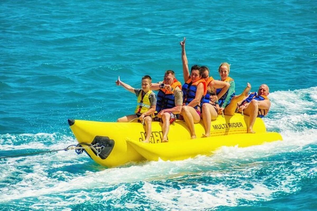 a group of people riding on a yellow raft in the water