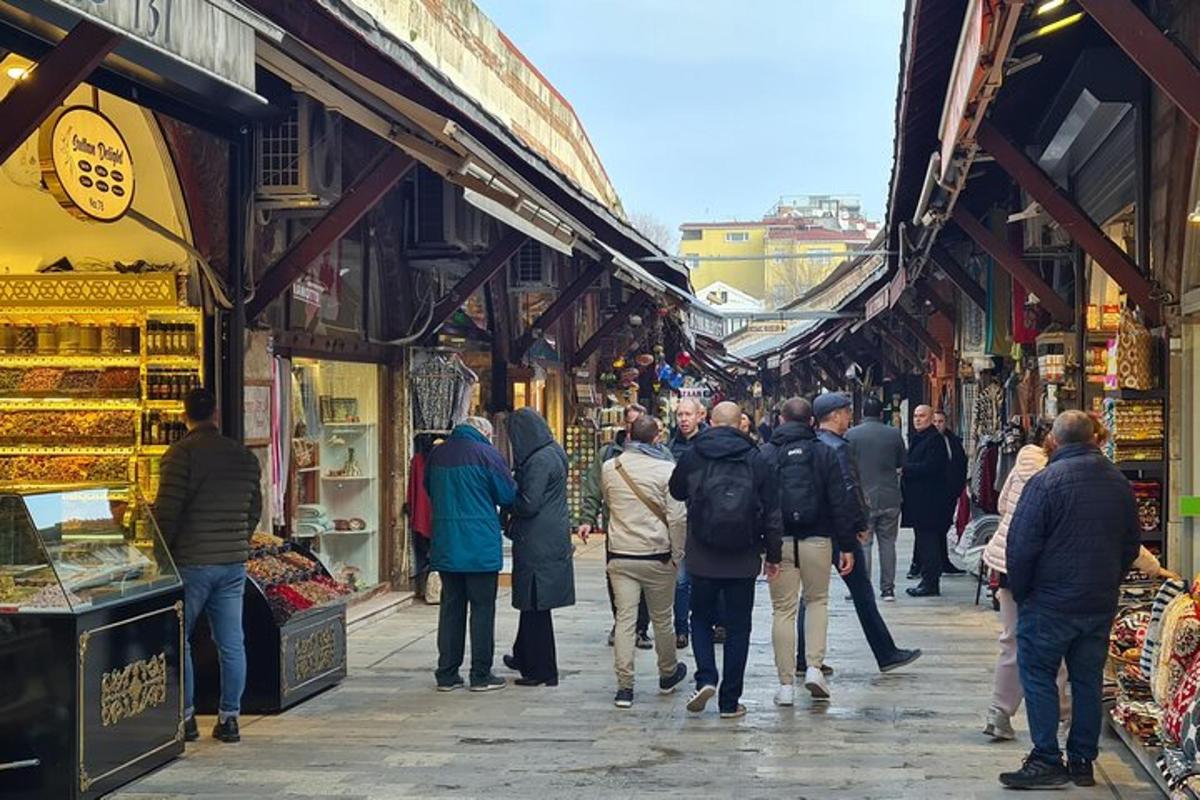 a group of people walking down a street in a market
