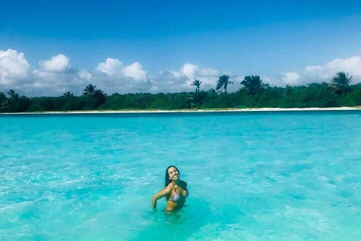 a woman sitting in the water in the ocean