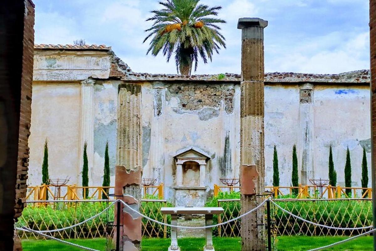 an old building with a palm tree in the background