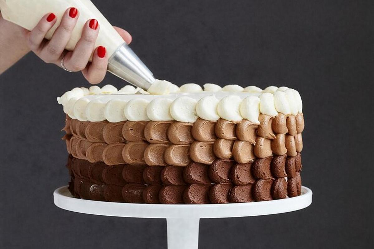 a woman is cutting a chocolate cake with a knife