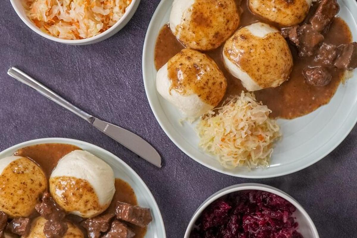 a table topped with plates of food with rice and beans
