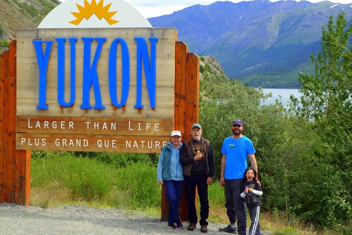 a family poses in front of the sign for the virgin sign