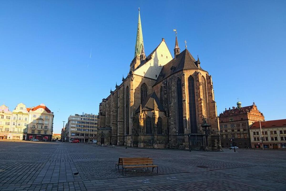 a church with a bench in the middle of a street