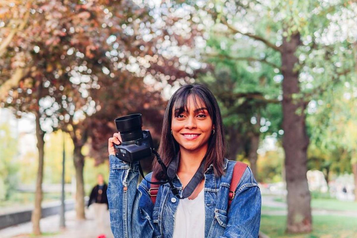 a woman holding a camera in a park
