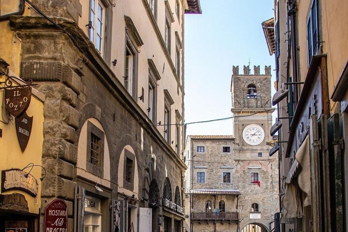 an alley with a clock tower in a city