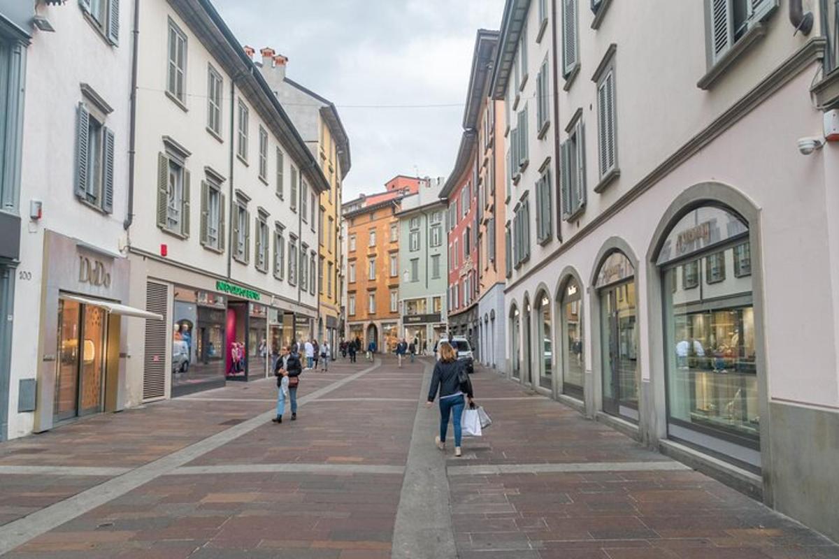 a woman walking down a city street with buildings