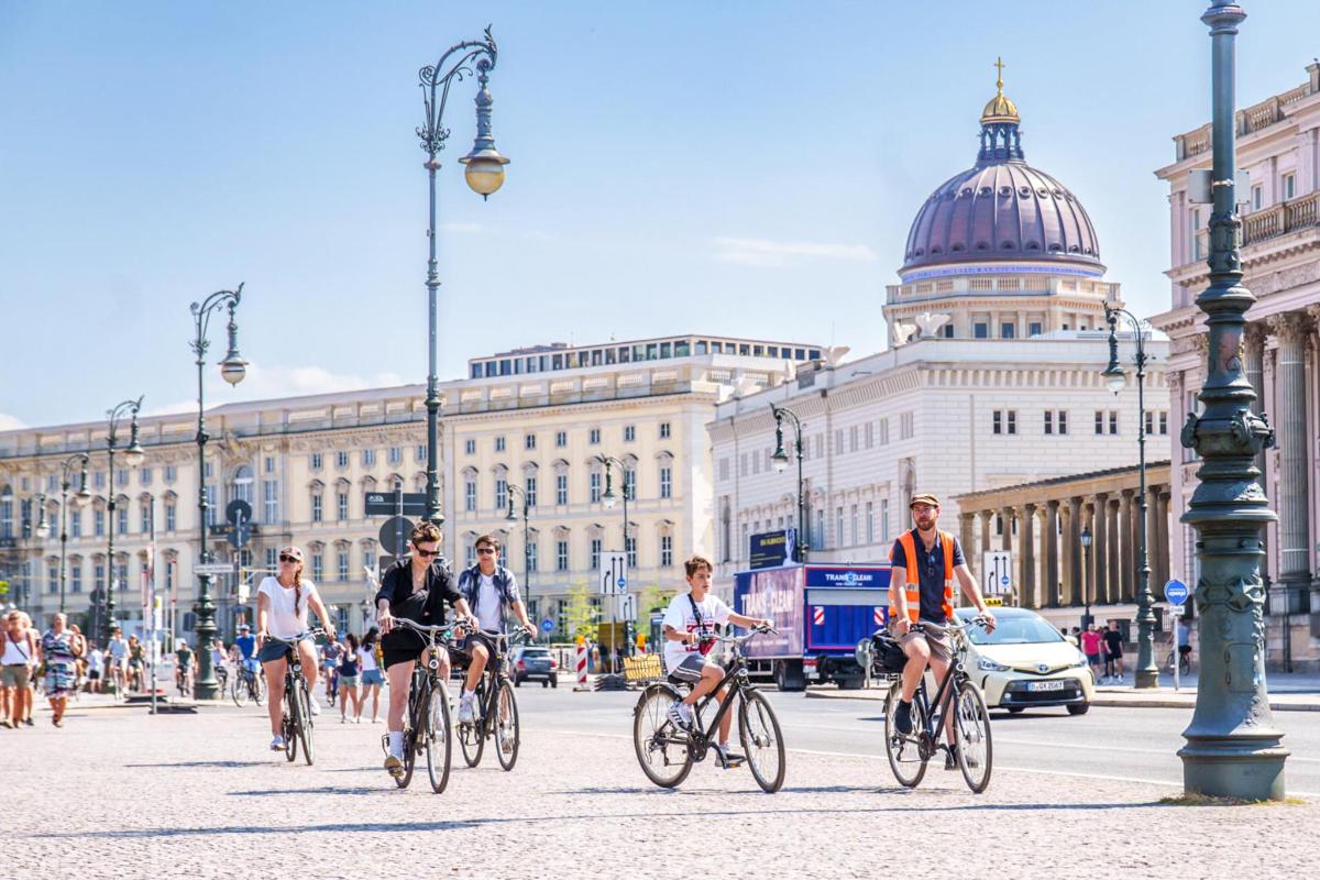 a group of people riding bikes down a city street