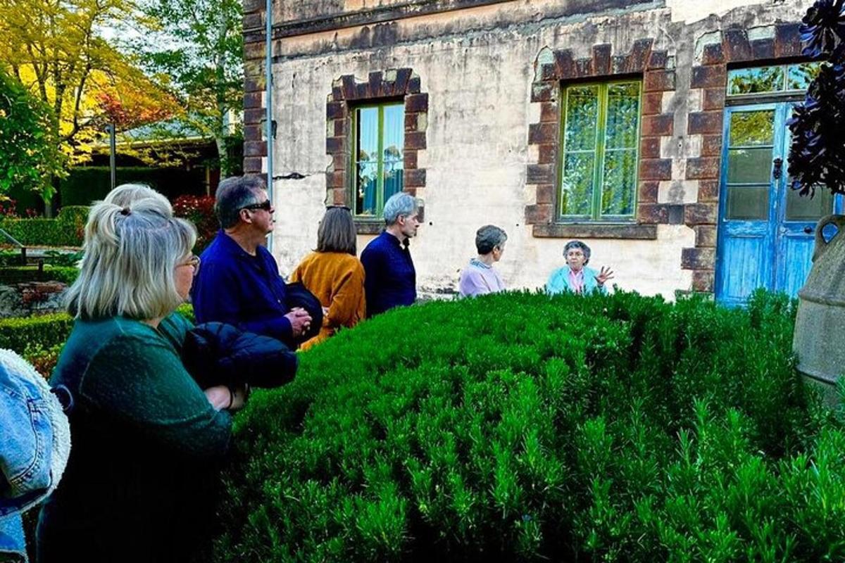 a group of people standing outside of a house