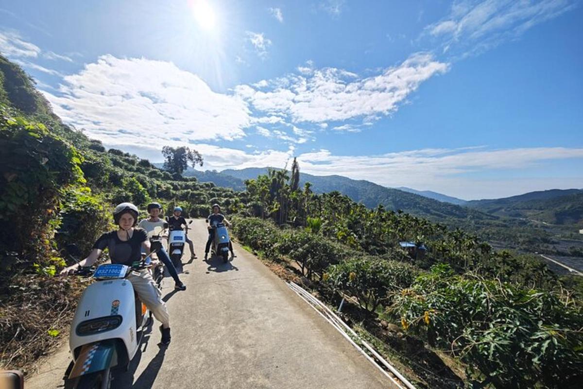 a group of people riding motorcycles down a road