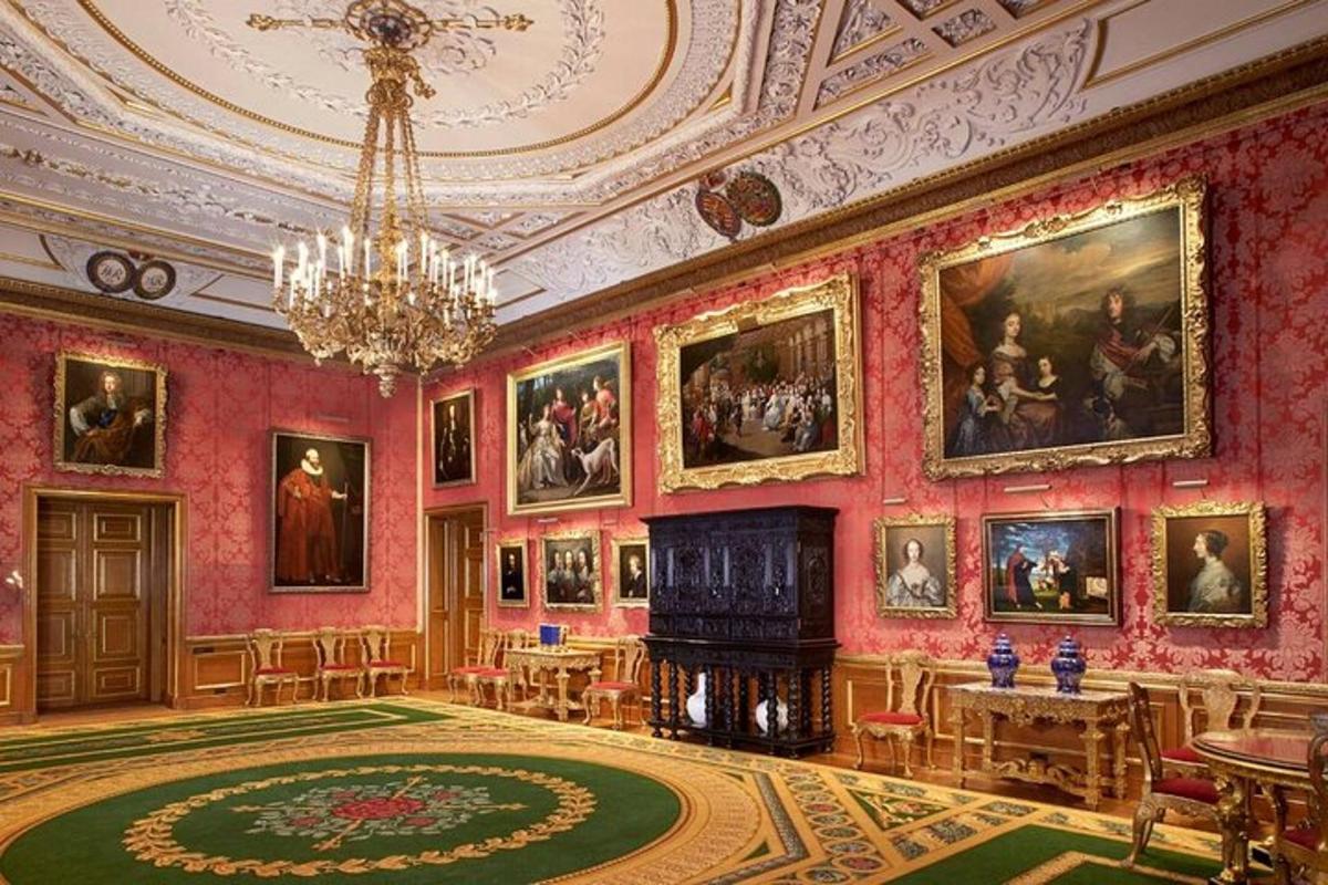 a room with paintings on the walls and a chandelier