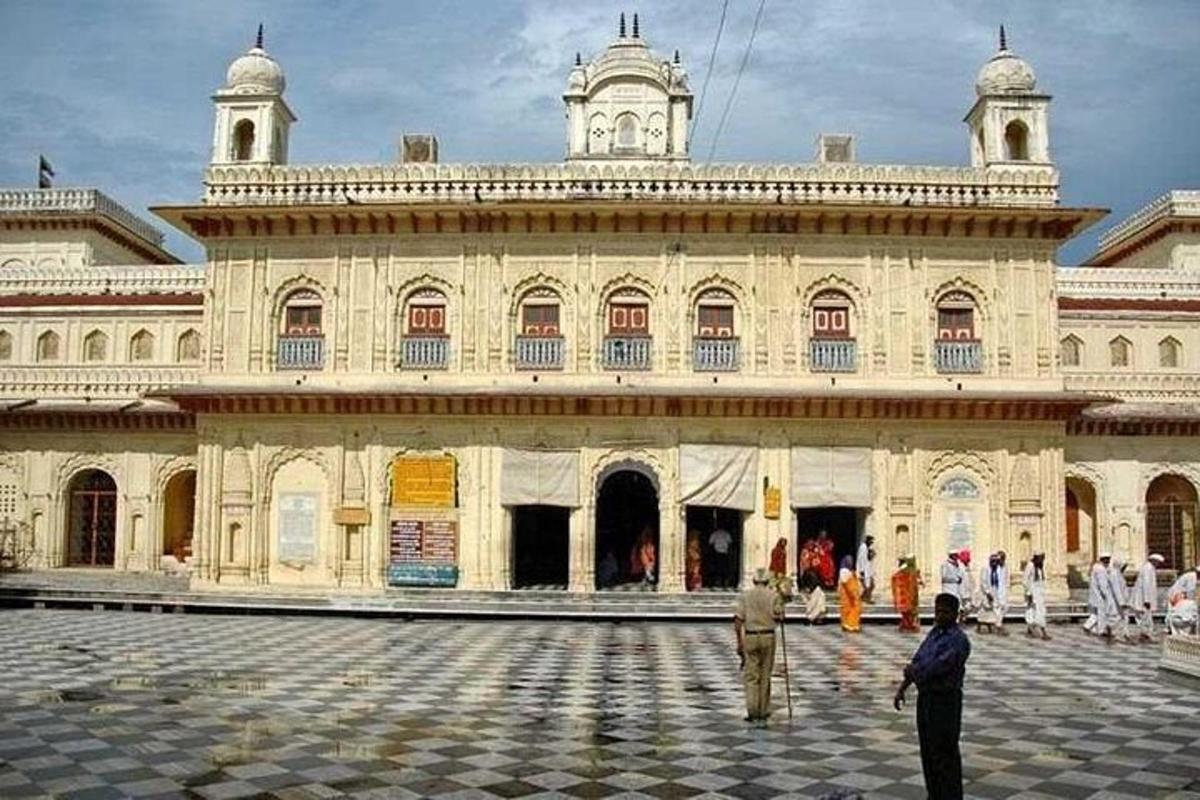 a man standing in front of a large building