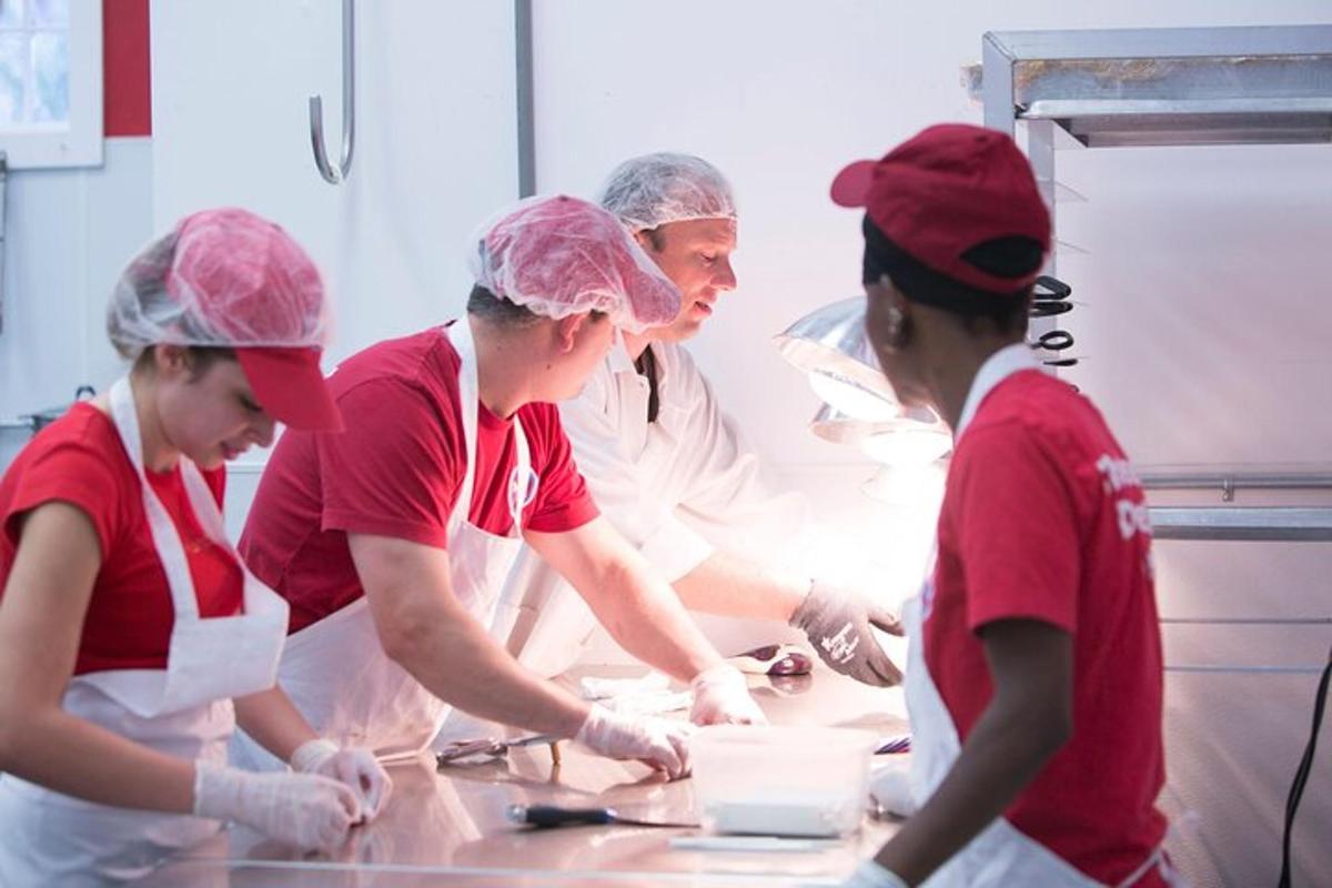 a group of people in a kitchen preparing food