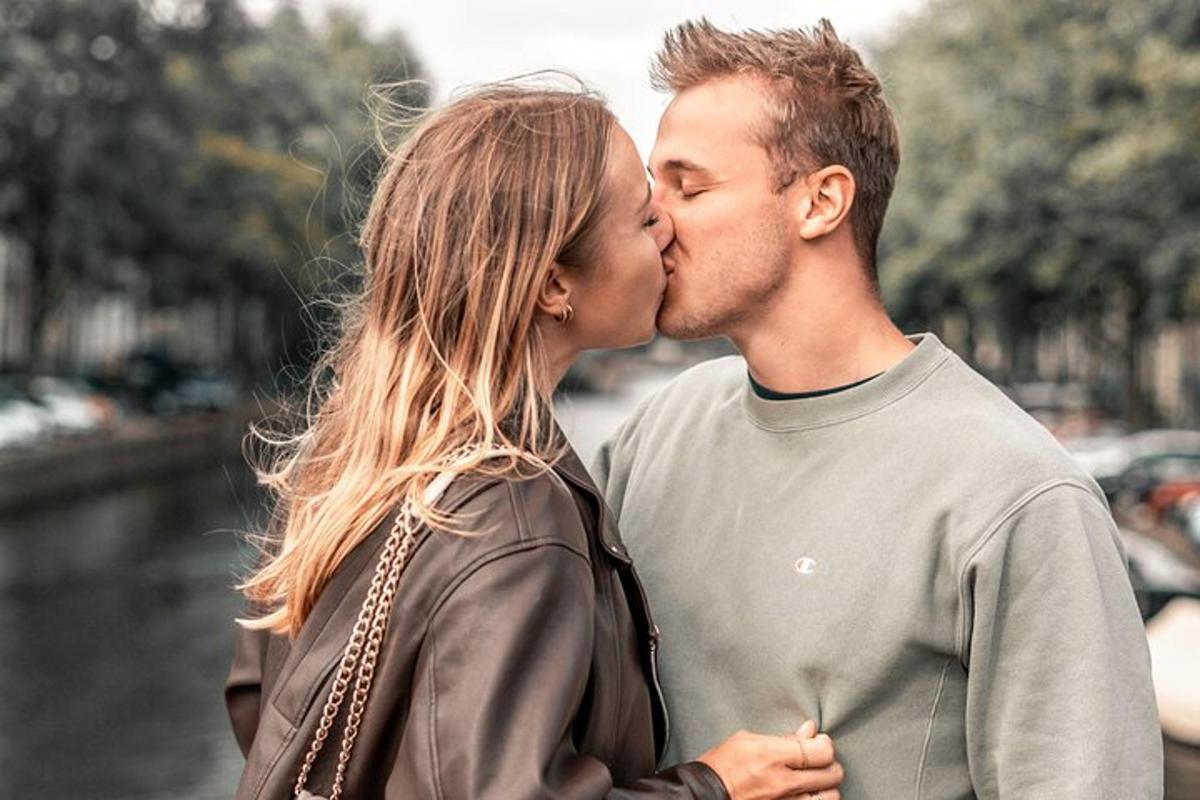 a man and a woman kissing each other