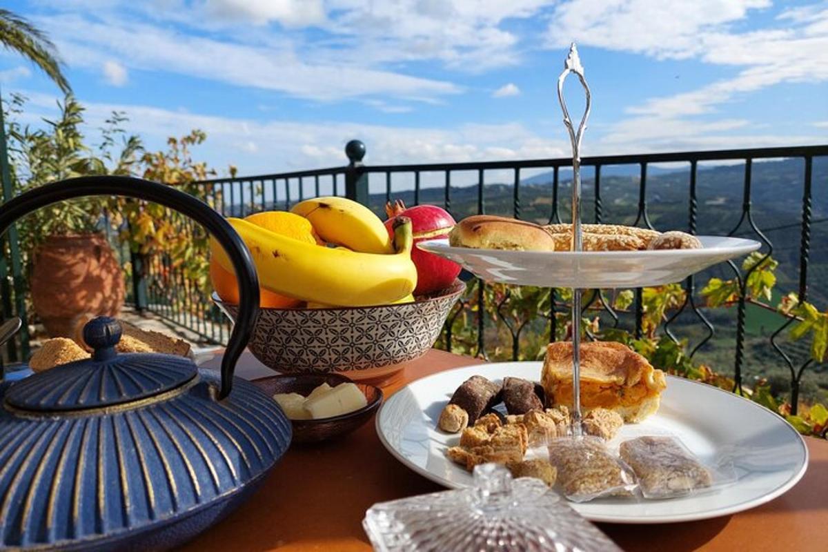 a table with two plates of food and a bowl of fruit