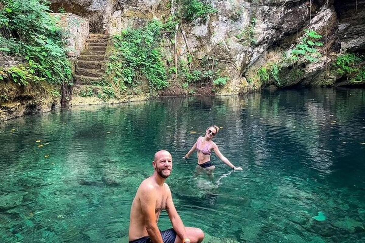 a man and woman swimming in a river