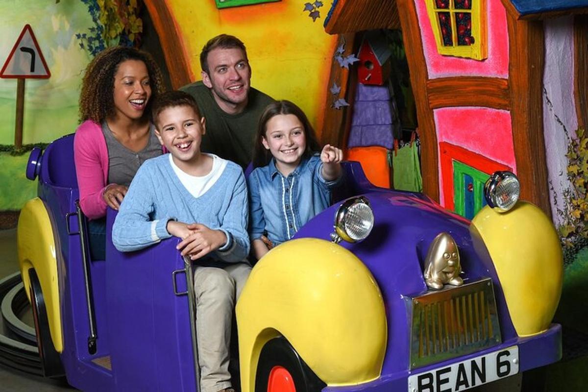 a family sitting in a car in a toy car ride