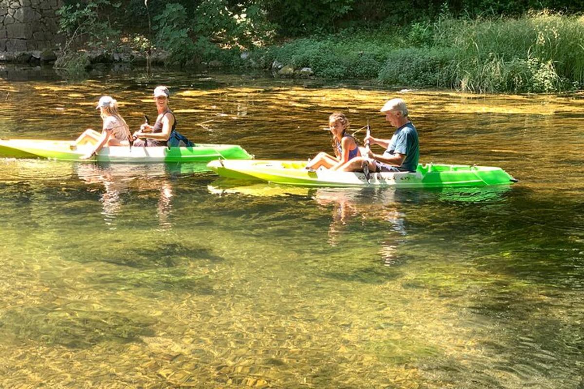 a group of people sitting on kayaks in the water
