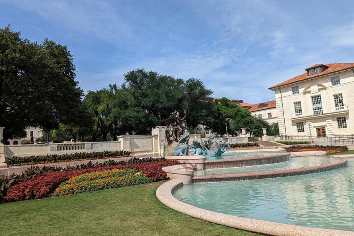 a park with a fountain in front of a building