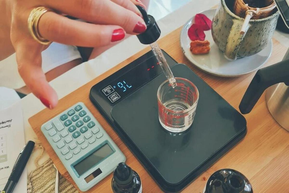 a person is holding a glass on a table